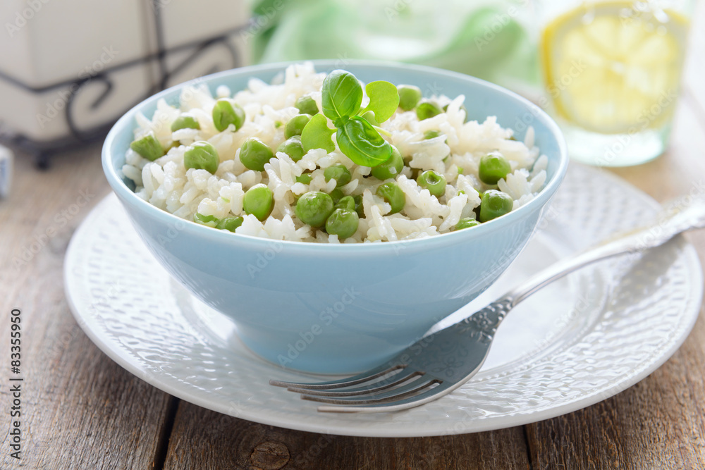 Risotto with green peas in blue bowl Risotto with green peas in blue bowl
