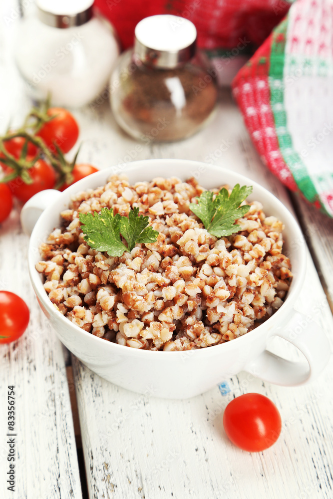 Buckwheat in bowl on white wooden background Buckwheat in bowl on white wooden background