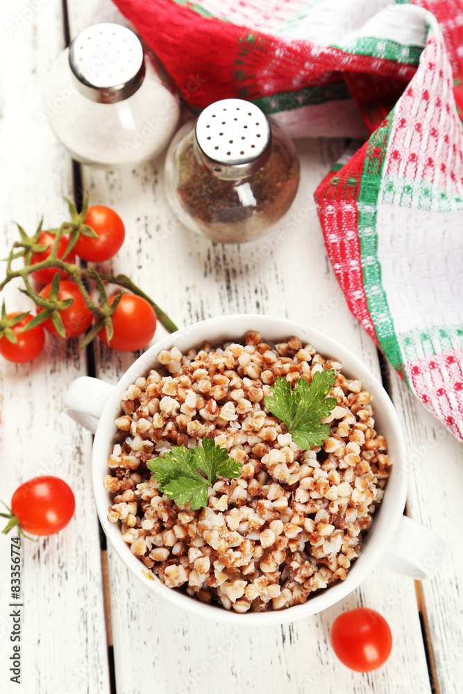 Buckwheat in bowl on white wooden background Buckwheat in bowl on white wooden background
