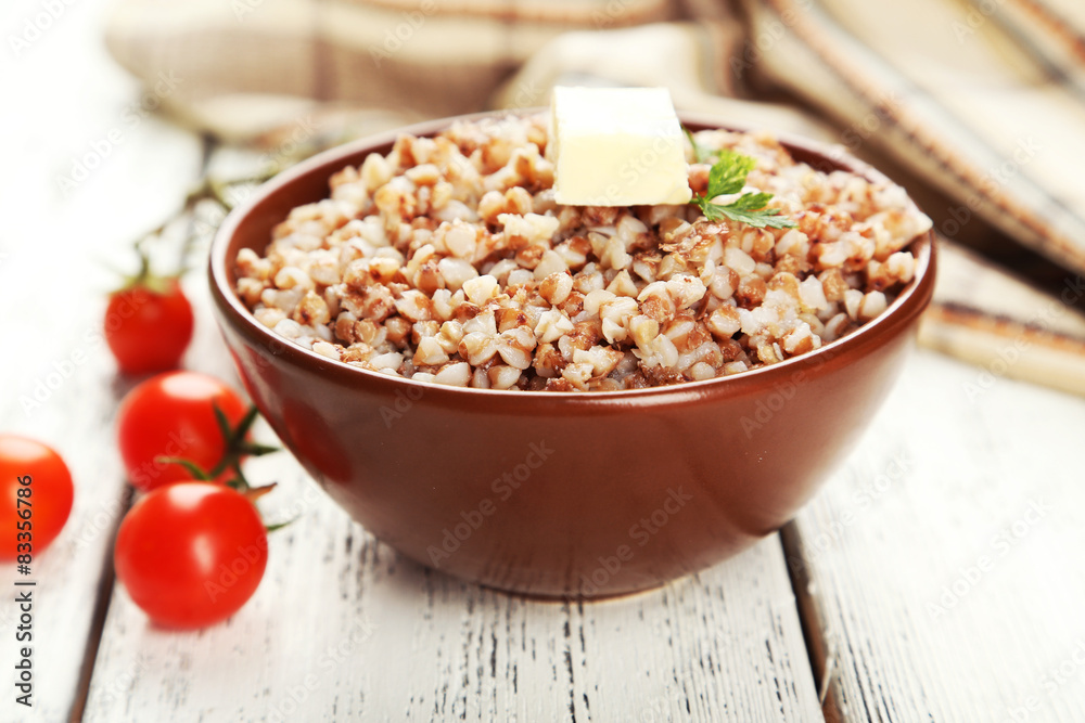 Buckwheat in bowl on white wooden background Buckwheat in bowl on white wooden background