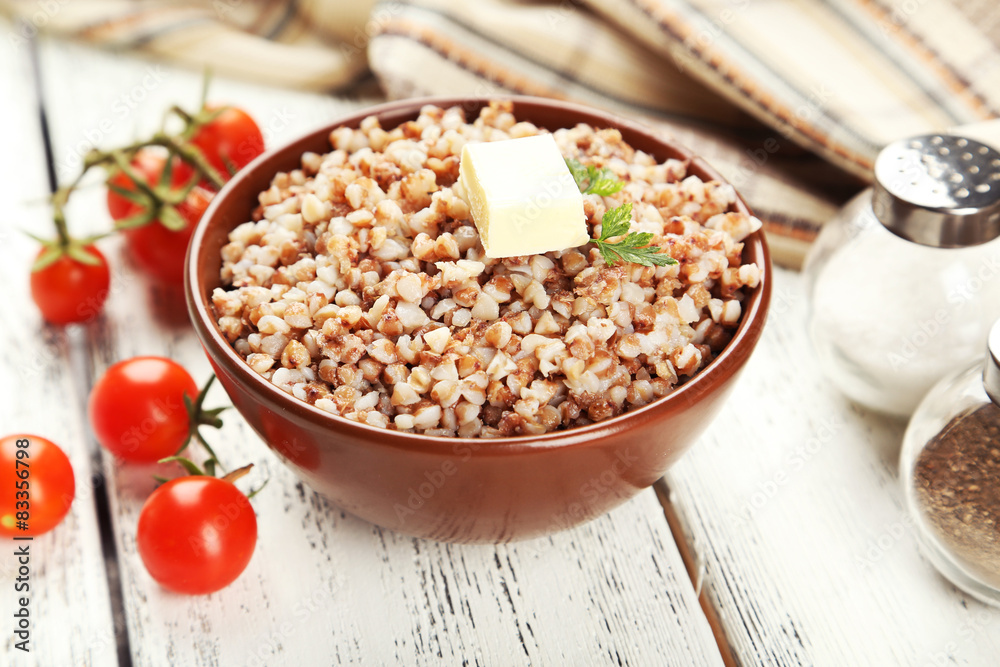 Buckwheat in bowl on white wooden background Buckwheat in bowl on white wooden background