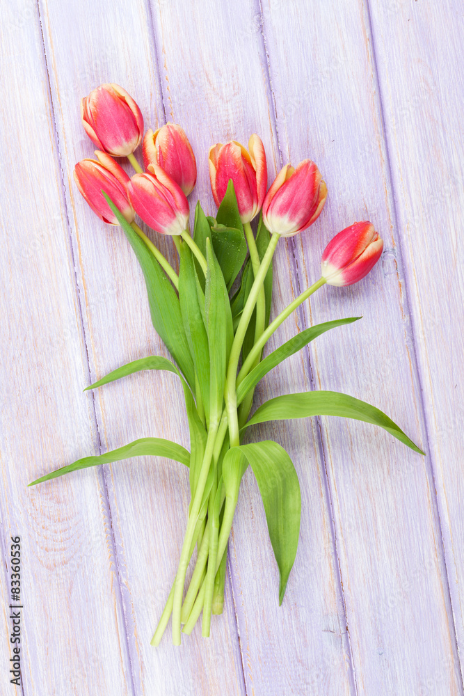 Fototapeta premium Colorful tulips on wooden table