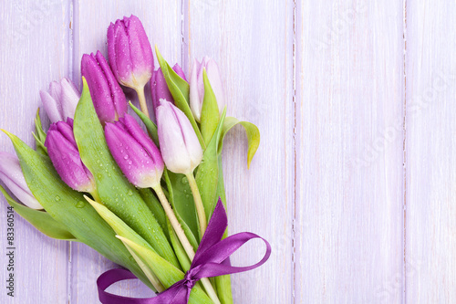 Fototapeta Naklejka Na Ścianę i Meble -  Purple tulips over wooden table