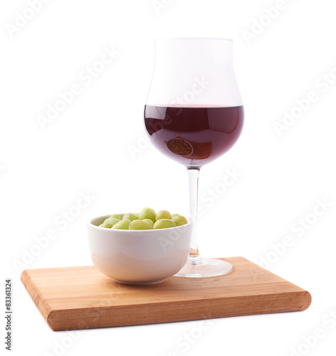 Glass of red wine and bowl of grapes