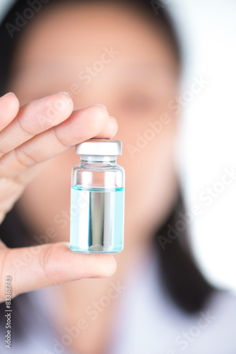 Closed up hand of Nurse hold injection vial and inspection