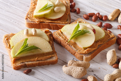 toast with fresh apple and peanut butter closeup. horizontal 