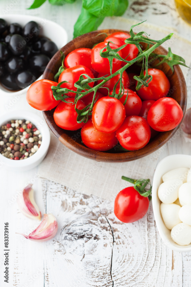 Tomatoes and mozzarella with basil leaves Tomatoes and mozzarella with basil leaves