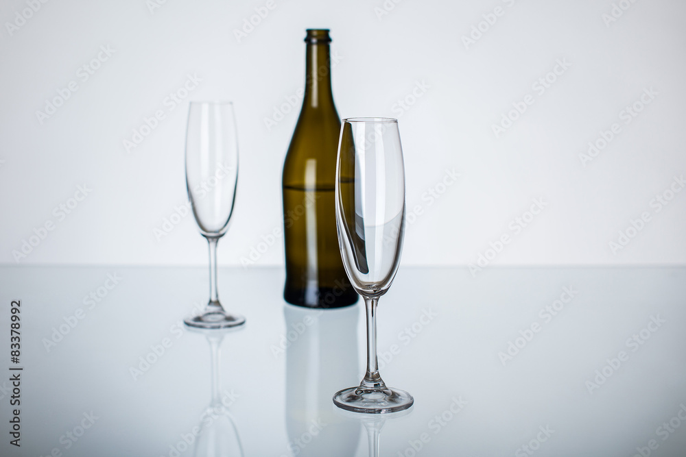 empty champagne glasses and bottle on the table