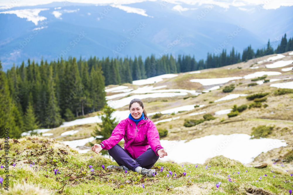 young caucasian girl sitting outdoors in mountains