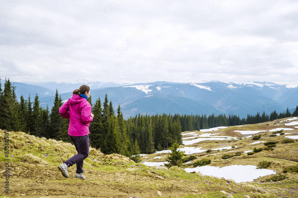 young caucasian female running in montains