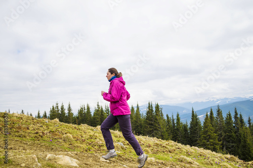 young caucasian female running in montains