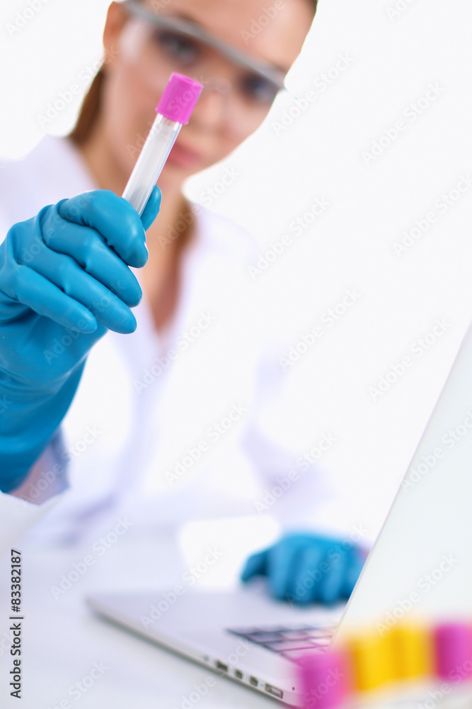 Woman researcher is surrounded by medical vials and flasks Woman researcher is surrounded by medical vials and flasks