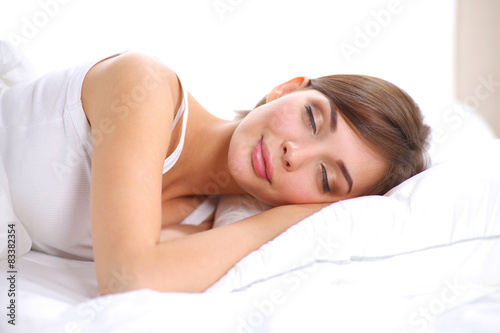 Beautiful girl sleeps in the bedroom  lying on bed