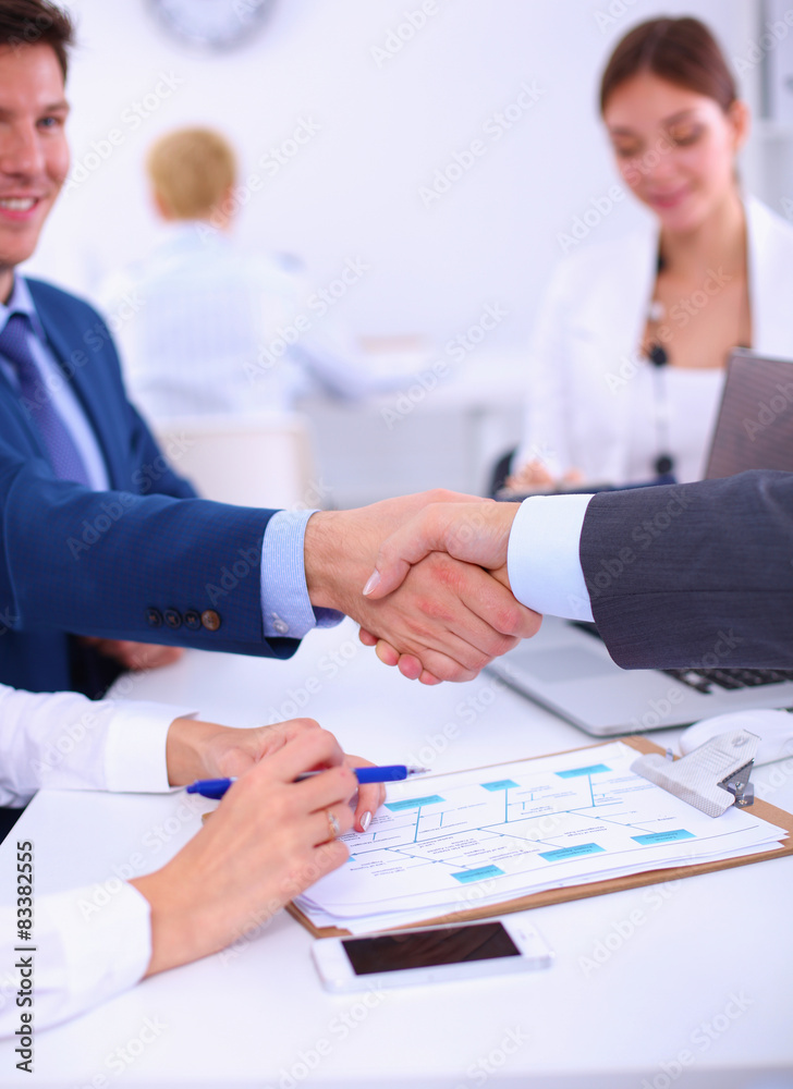 Business people shaking hands, finishing up a meeting Business people shaking hands, finishing up a meeting