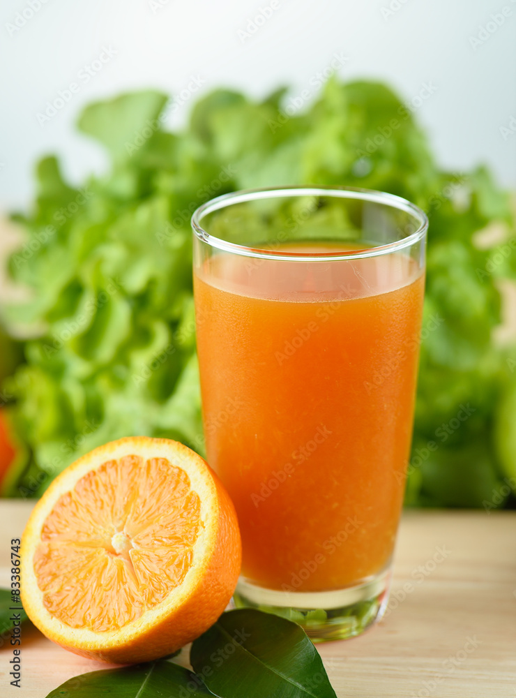 Orange juice in glass on wooden background Orange juice in glass on wooden background