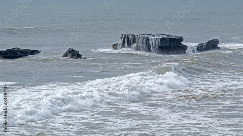 Seawater flows with stones. Uluwatu rocks. Bali. Indonesia photo