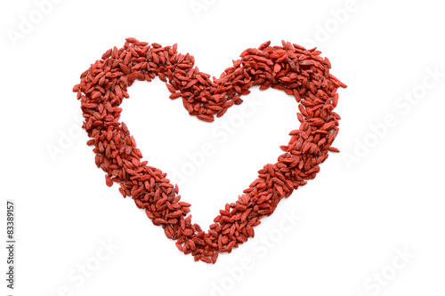 Red heart figure made from many dried Goji berries. Heart sign