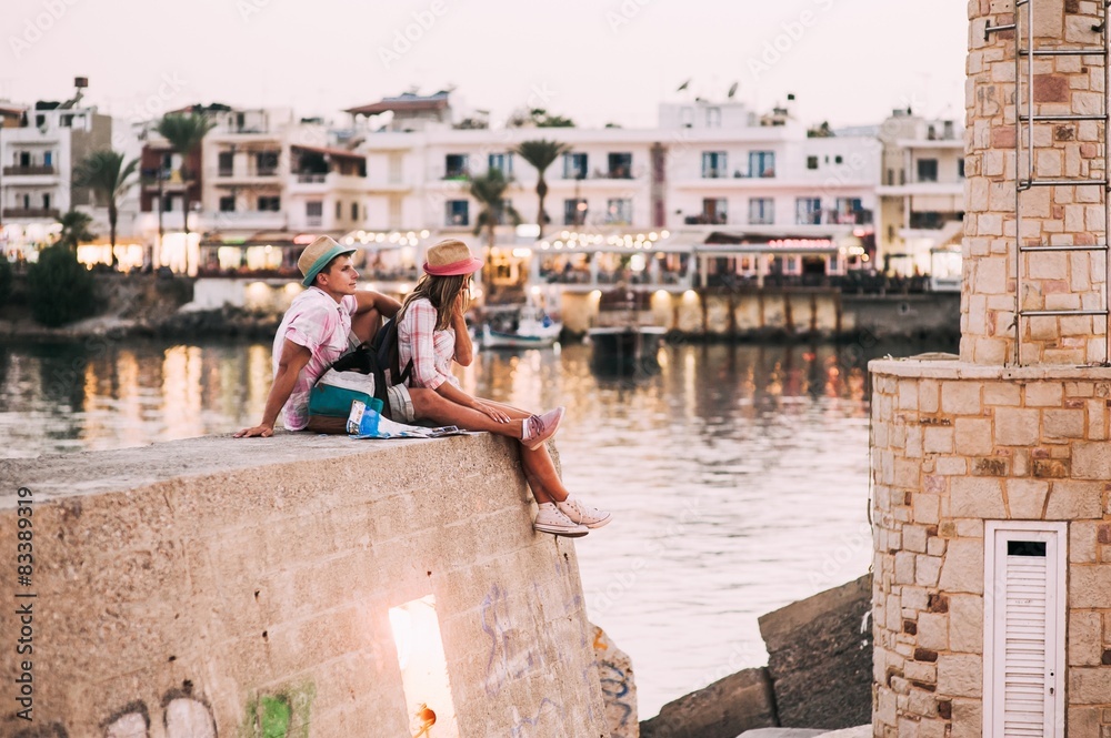 Walk a young couple on the waterfront in Greece