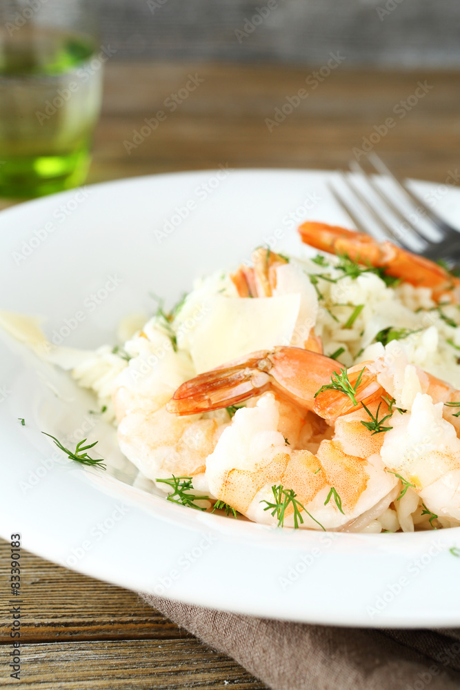 Delicious risotto with shrimp and dill on white plate Delicious risotto with shrimp and dill on white plate