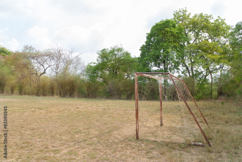 the old football goal under sunlight with forest background