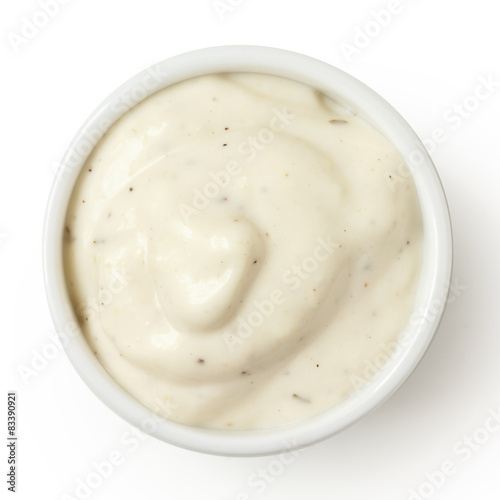 Small pot of garlic mayonnaise, isolated, detail, from above.