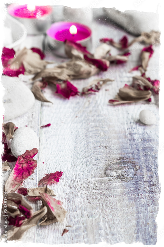 Stones candles petals rose wooden background