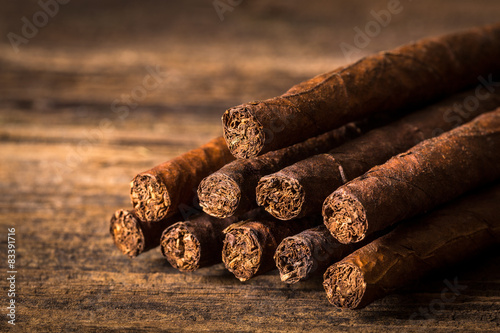 quality cigars on an old wooden table photo