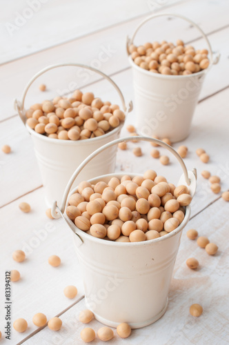 health food-soybean, soy pods in white bucket on wooden board