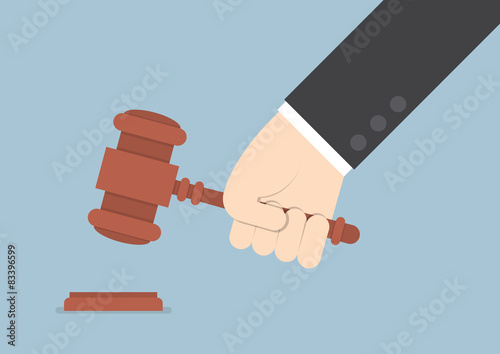 Businessman hand knocking judge's gavel