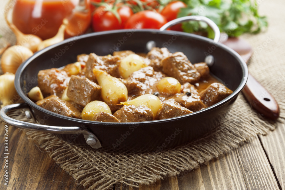 Stewed beef with onions and tomatoes, stifado Stewed beef with onions and tomatoes, stifado