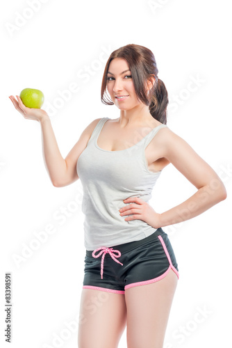 attractive girl in the sports form with green apple
