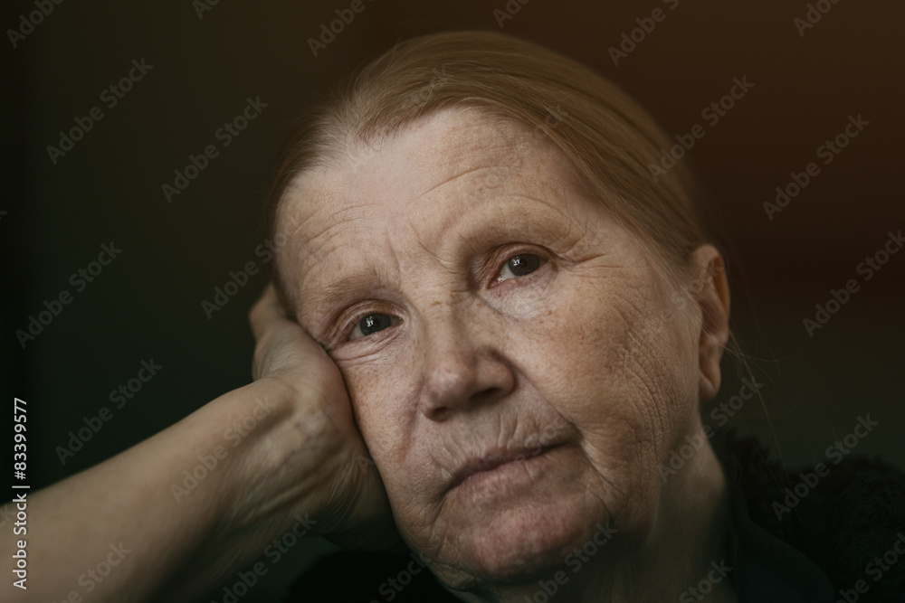 senior woman looking to the camera with sad look shalow DOF senior woman looking to the camera with sad look shalow DOF