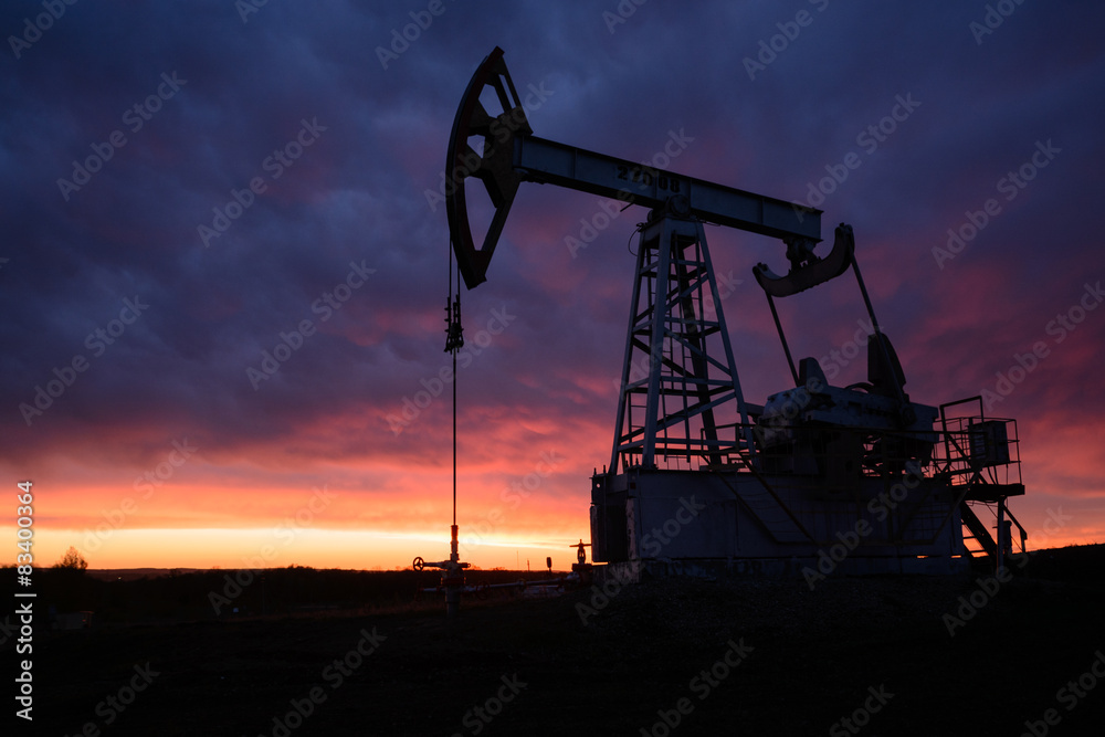 Oil pumping station at sunset Oil pumping station at sunset