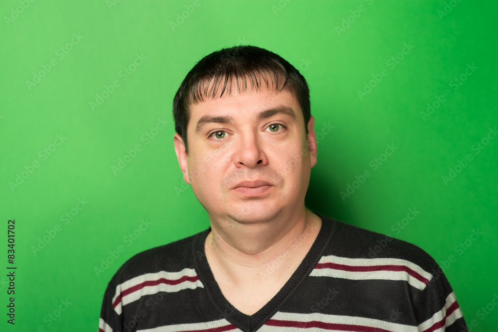 closeup of an attractive man on a green background closeup of an attractive man on a green background