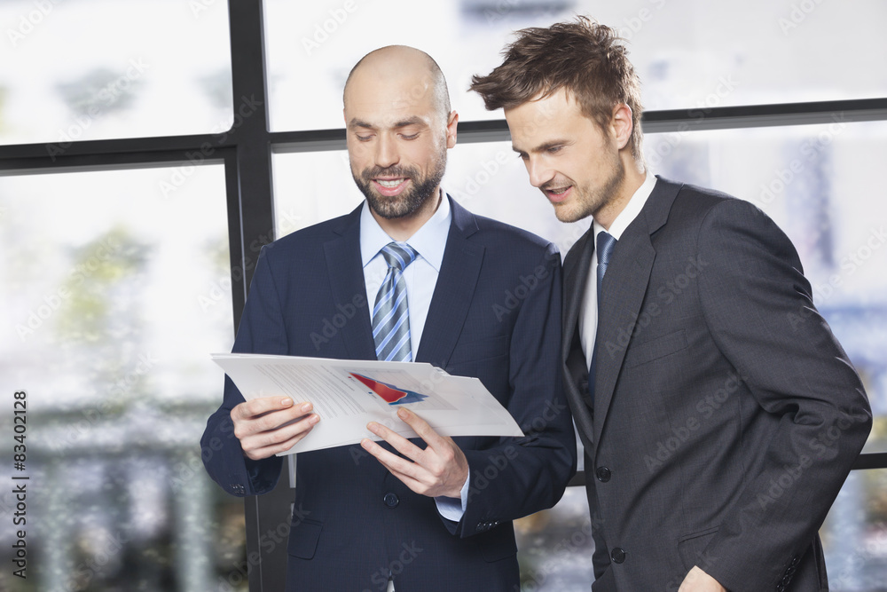 Two businessmen lookind at documents Two businessmen lookind at documents