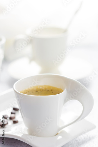 Cup of coffee on white wooden background