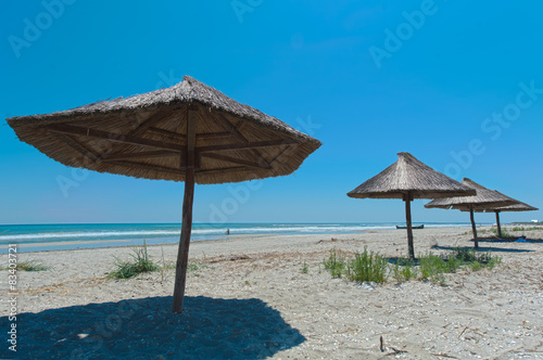 View of nice tropical empty sandy beach with umbrella