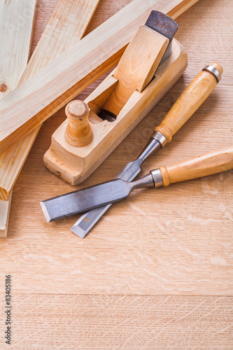 chisels and woodworkers plane on wooden board