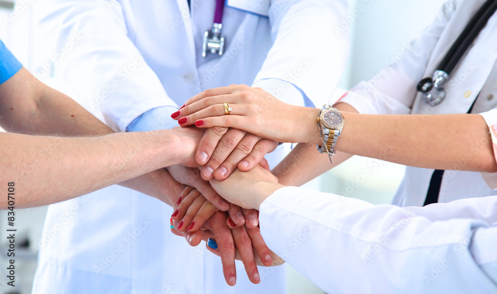 Doctors and nurses in a medical team stacking hands Doctors and nurses in a medical team stacking hands