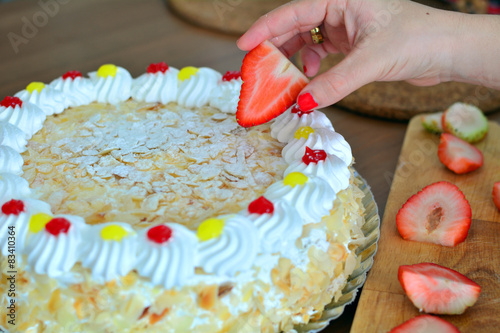 Hand decorating a cake photo