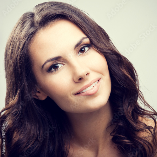 Portrait of beautiful young smiling brunette woman