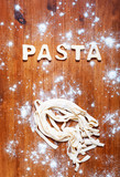 Letters of dough and pasta on the wooden table
