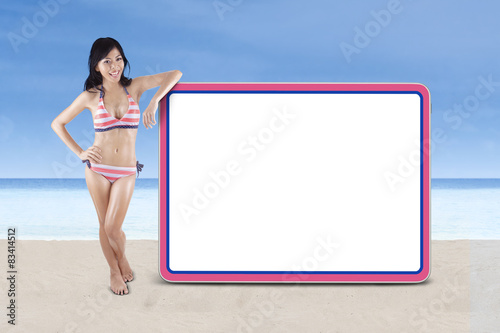 Woman wearing striped bikini with copyspace