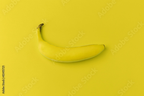 Banana on yellow background. Modern food background