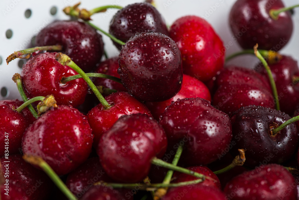Fresh clean organic ripe cherries in colander Fresh clean organic ripe cherries in colander