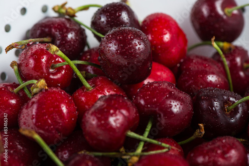 Fresh clean organic ripe cherries in colander