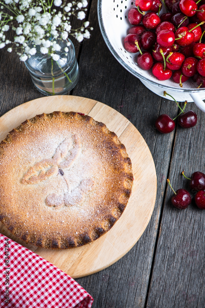 Homemade cherry pie served on rustic table