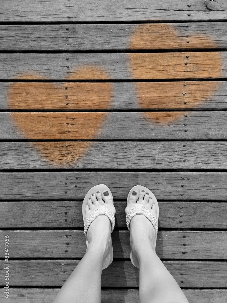 feet and heart on wood floor. 