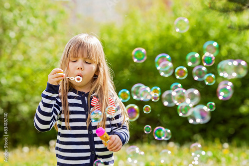 Beautiful little blonde girl, playing outdoor, springtime