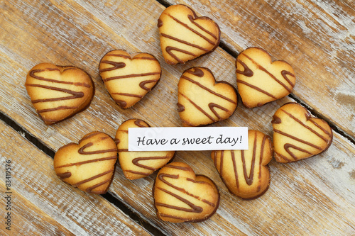 Have a sweet day card with heart shaped cookies on rustic wood 